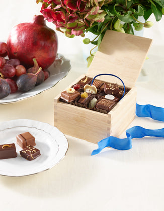 Our Hanukkah chocolate collection pictured alongside ingredients like pomegranate and fig.