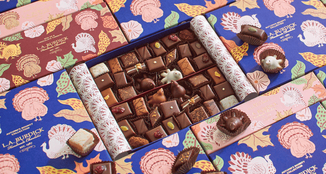 Beautifully illustrated Thanksgiving assortment boxes with chocolates nested inside.