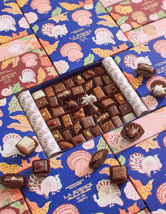 Beautifully illustrated Thanksgiving assortment boxes with chocolates nested inside.