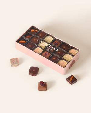 Light pink box containing assorted square bonbons.