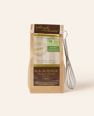 Bag of L.A. Burdick chocolate with a whisk on a cream background