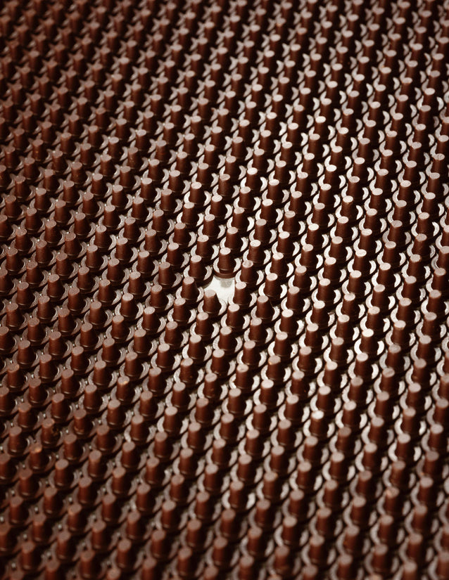Hundreds of the chocolate top hats for our Chocolate Snowmen sit in rows at our factory.