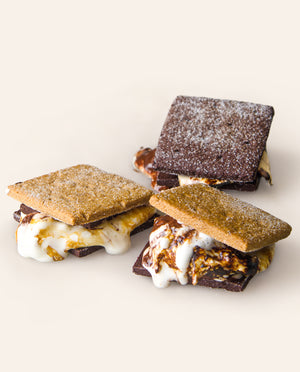Three s'mores with chocolate and plain graham crackers, showing melting marshmallows and chocolate. 