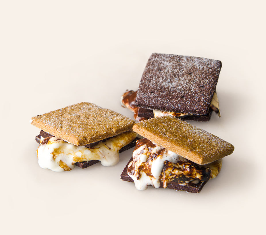 Three s'mores with chocolate and plain graham crackers, showing melting marshmallows and chocolate. 