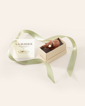 Milk Chocolate Elephant with white chocolate tusks tucked into a gift box and finished with a green satin ribbon.