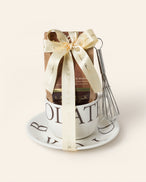 Gift set with our signature milk drinking chocolate and whisk tucked inside our L.A. Burdick branded cup and saucer.