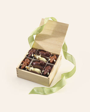 Open wooden box displaying 2 Dark Chocolate Elephants, 2 Milk Chocolate Elephants, 2 Dark Chocolate Rhinos, and 2 White Chocolate Rhinos.