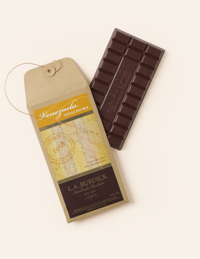 Single-source dark chocolate bar from Venezuela, shown next to it's paper packaging.