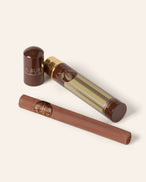 Chocolate Cigar shown next to it's gold cylindrical packaging.