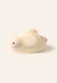 White chocolate bunny bonbon on a cream background
