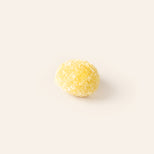 Yellow marzipan egg on a cream background