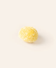 Yellow marzipan egg on a cream background