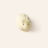 White chocolate sheep bonbon with on a light cream background