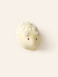 White chocolate sheep bonbon with on a light cream background