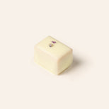 Rectangular white chocolate bonbon on a cream background