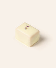 Rectangular white chocolate bonbon on a cream background