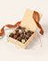 Wooden box filled with 16 dark, milk and white chocolate mice with silk tails. Tied with a pumpkin colored ribbon on a cream background.