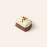 A two tone, dark and white chocolate rectangular bonbon.