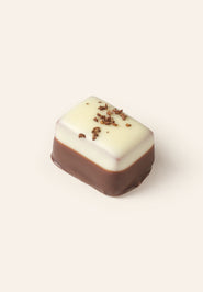 A two tone, dark and white chocolate rectangular bonbon.