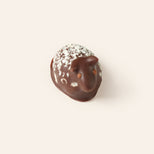 dark chocolate sheep bonbon on a cream background