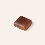 Square dark and milk chocolate bonbon on a cream background