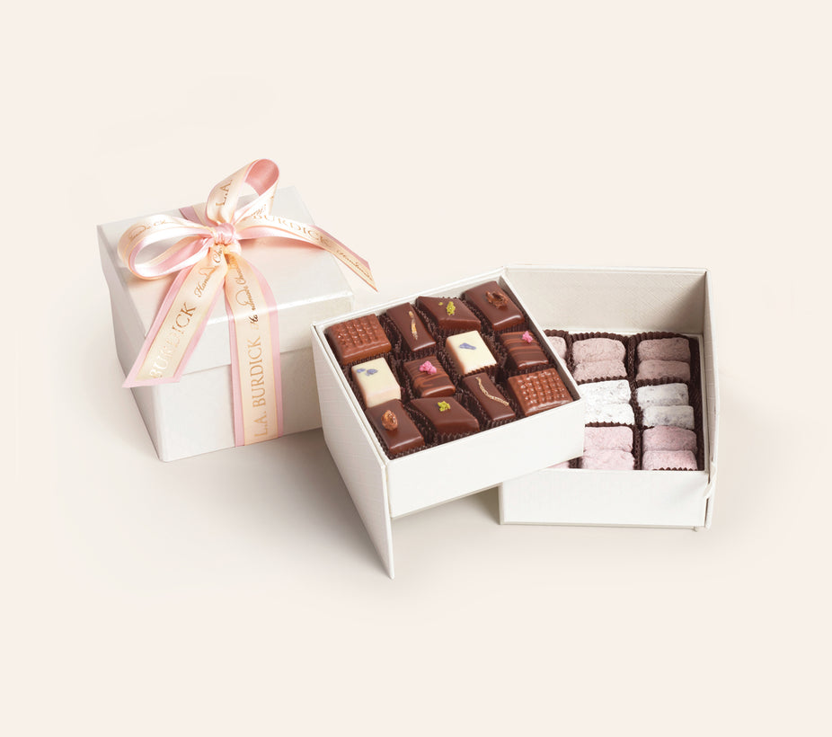 Spring Bonbon Assortment of fruit and floral bonbons in a white two-tiered gift box with pink ribbon.