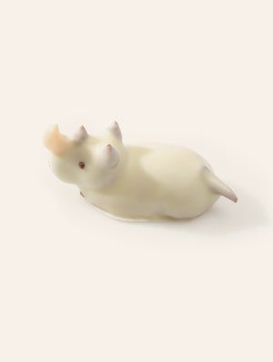 White chocolate rhino bonbon on a cream background