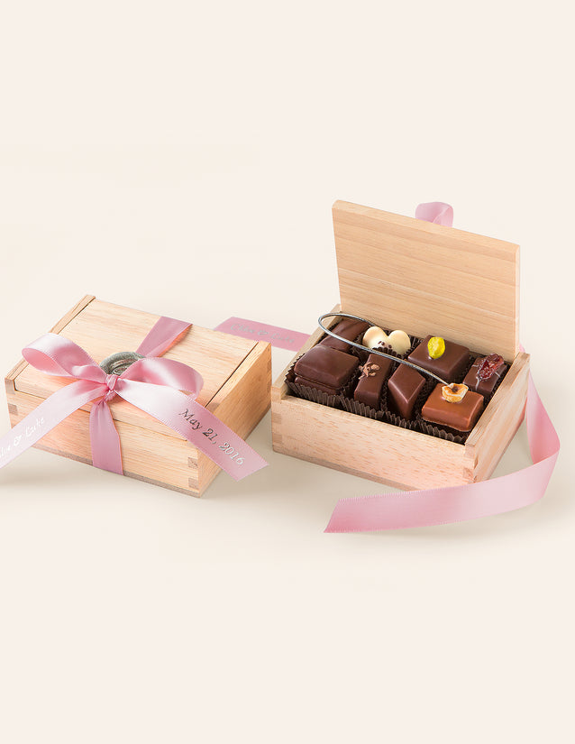 Petite wooden box filled with assorted chocolates, including one Chocolate Mouse, finished with a pink satin ribbon and wax seal.