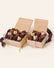 Two wooden gift boxes filled with chocolate mice on a white background