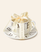 L.A. Burdick branded cup and saucer wrapped with a satin bow and ready to gift.